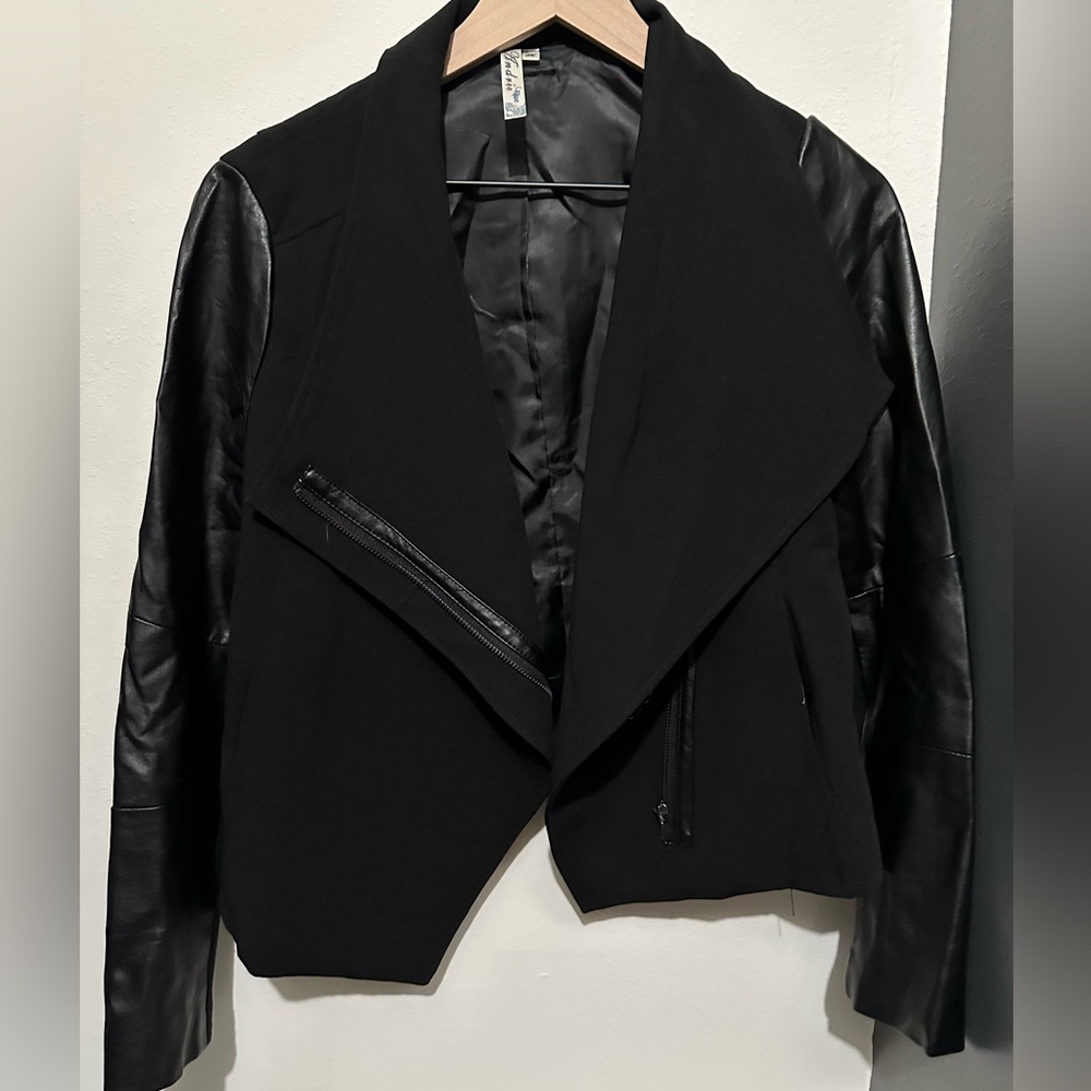 Black blazer with faux leather accents.